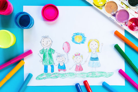 Childrendrawing pencil happy family mom, dad, son, daughter sunny day on the lawn and paint accessories, brush, felters gouache, watercolor on a blue background flat lay top view from above