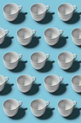 Pattern. Cup concept. Group of white cups on blue background. Creative style.