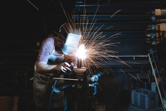 Blacksmith using a welding torch