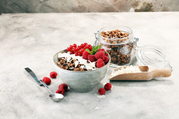 granola healthy breakfast with natural yogurt, muesli and berries