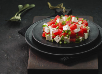Summer salad of watermelon,feta cheese,fresh mint leaves and micro greens.Close-up with copy space.
