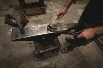 Low section of blacksmith working in workshop