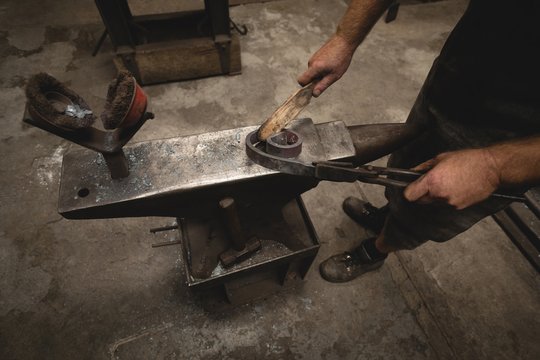 Low section of blacksmith working in workshop