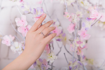 Obraz na płótnie Canvas Woman's hands with jewelry rings. Close-up beauty and fashion portrait. Girl with pastel manicure. Jewelry and luxury concept. Beautiful woman with stylish accessories