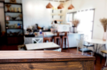 Selected focus empty brown wooden table and Coffee shop or restaurant blur background with bokeh image. for your photomontage or product display.