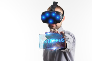 Business, Technology, Internet and network concept. Young businessman working in virtual reality glasses sees the inscription: Antivirus