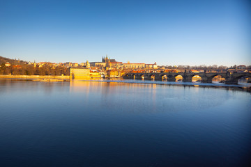 Charles Bridge and Prague castle over river Vltava at sunrise light in early morning