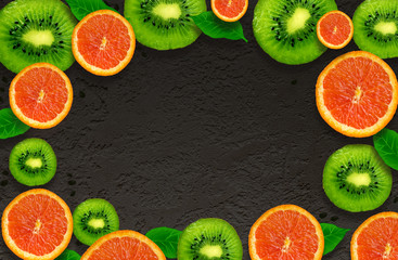 Kiwi and orange on isolated black background