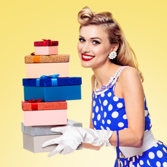 Woman in pin-up style dress with gift boxes