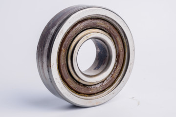 Used rusty metal ball bearing on white background.