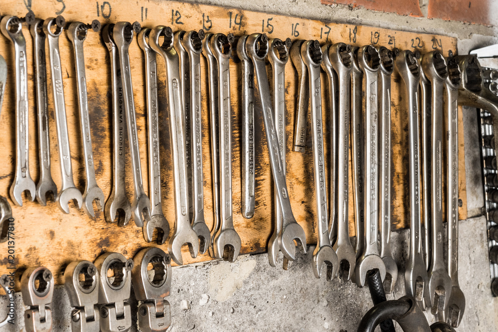 Wall mural set of flat spanners. tool kit for the car. silver coloured spanners lying side by side.