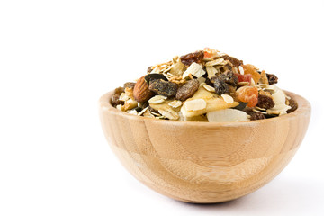 Muesli and dried fruit in wooden bowl isolated on white background. 