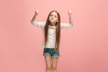 Portrait of angry teen girl on a pink studio background