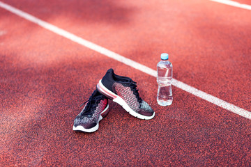 Shoes for running and bottle of water