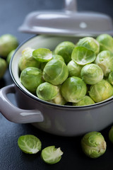Closeup of raw fresh brussels sprouts in a pot, selective focus, vertical shot