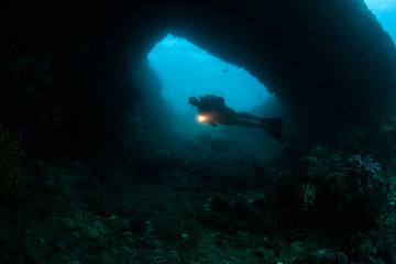 Scuba Diver Exploring Deep Cavern © ead72