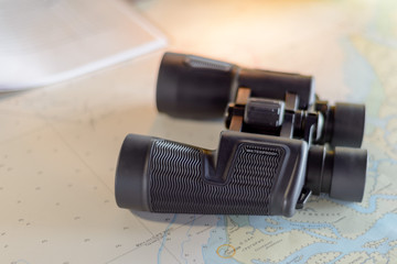 Binoculars on navigational map