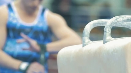 Hands of athletic male taping his hands in preparation for competition