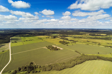 Obraz premium Countryside roads and fields in summer time, Latvia.