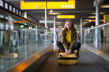 the girl is riding on the travolator