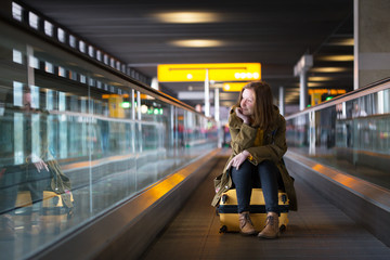 the girl is riding on the travolator