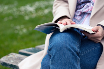  girl at the park reading a book