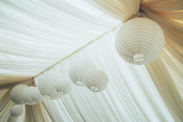 Canopy from fabric of dairy color with the Chinese  flashlights