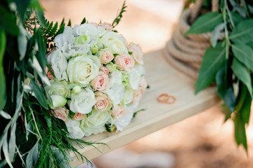 Wedding decor. A bridal bouquet on a decorative swing.