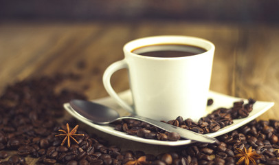 Fototapeta premium black coffee cup on old wood with coffee beans and old grinder