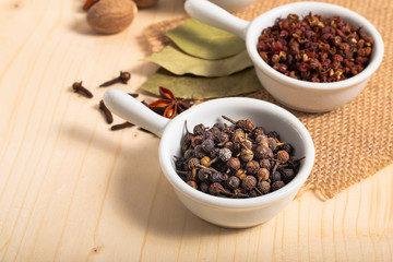 Exotic spices concept Chinese Asian Spices mix  , black peppers, Sichuan peppercorns, star anise pods, bay leave, nutmegs, cloves with copy space