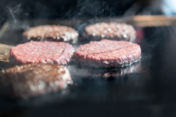Hamburger cutlet frying on pan.Natural meet loaf pieces cooking in the kitchen.Burger sandwich meat...