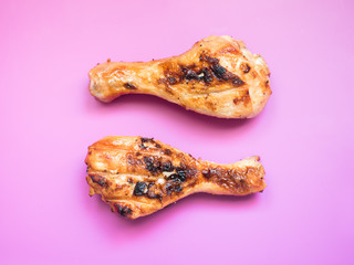 Grilled chicken drumsticks on a bright colored background Selective focus