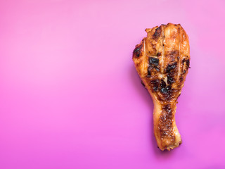 Grilled chicken drumsticks on a bright colored background Selective focus
