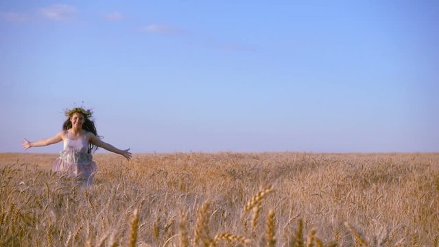 girl running on golden wheat field, slow motion