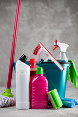 Cleaning supplies on grey background
