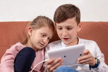 Two kids playing with digital tablet