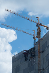 high crane working with blue sky background for construvtion and building condo