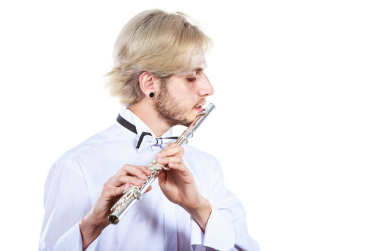 Male flutist playing his flute