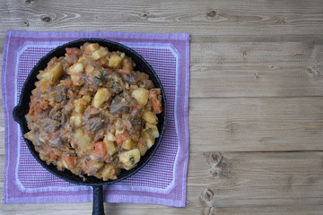 stewed vegetables with beans and meat in a frying pan