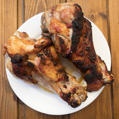 Appetizing roast turkey shank on a plate close up