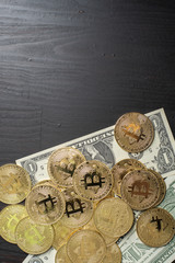 Bitcoin and dollar money on wooden desk
