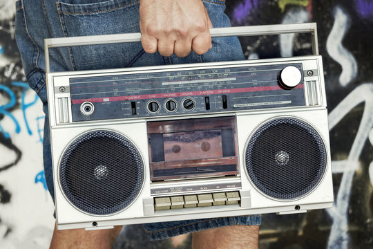 Person holding vintage boombox