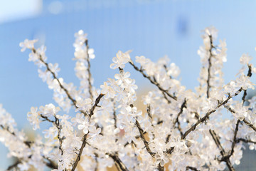 plastic flowers on a metal tree