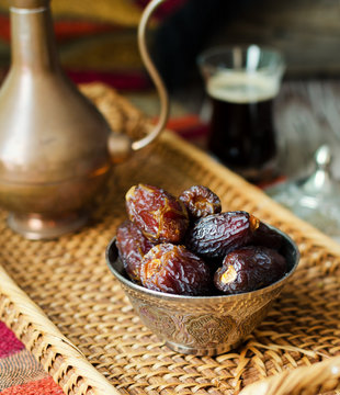 Eid mubarak with arabic coffee pot and dates. Dried dates and coffe