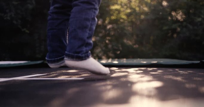 Small child jumping on a trampoline