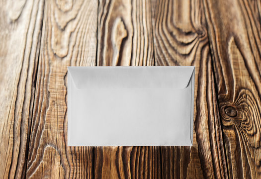 Two white envelopes with letters on old wooden dark background. Blanks for the designer. Concepts, ideas for postal services and e-mail.
