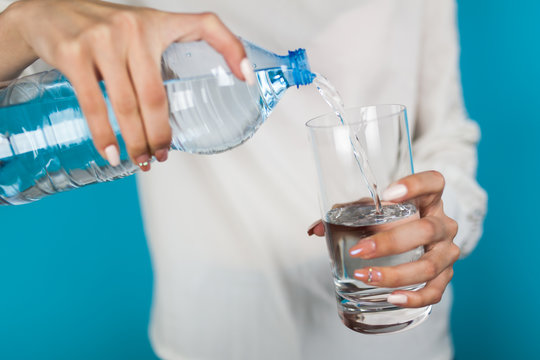 Woman filling a glass of water