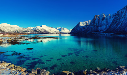 Naklejka premium Panoramic view of beautiful winter lake with snowy mountains at Lofoten Islands in Northern Norway