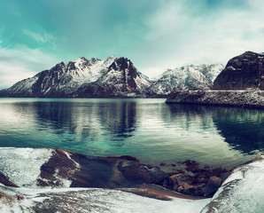 Scenic view of beautiful winter lake with snowy mountains at Lofoten Islands in Northern Norway