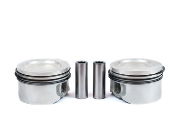 Close-up of spare parts two new pistons with connecting rods for a gasoline engine with installed sets of piston rings on an isolated white background